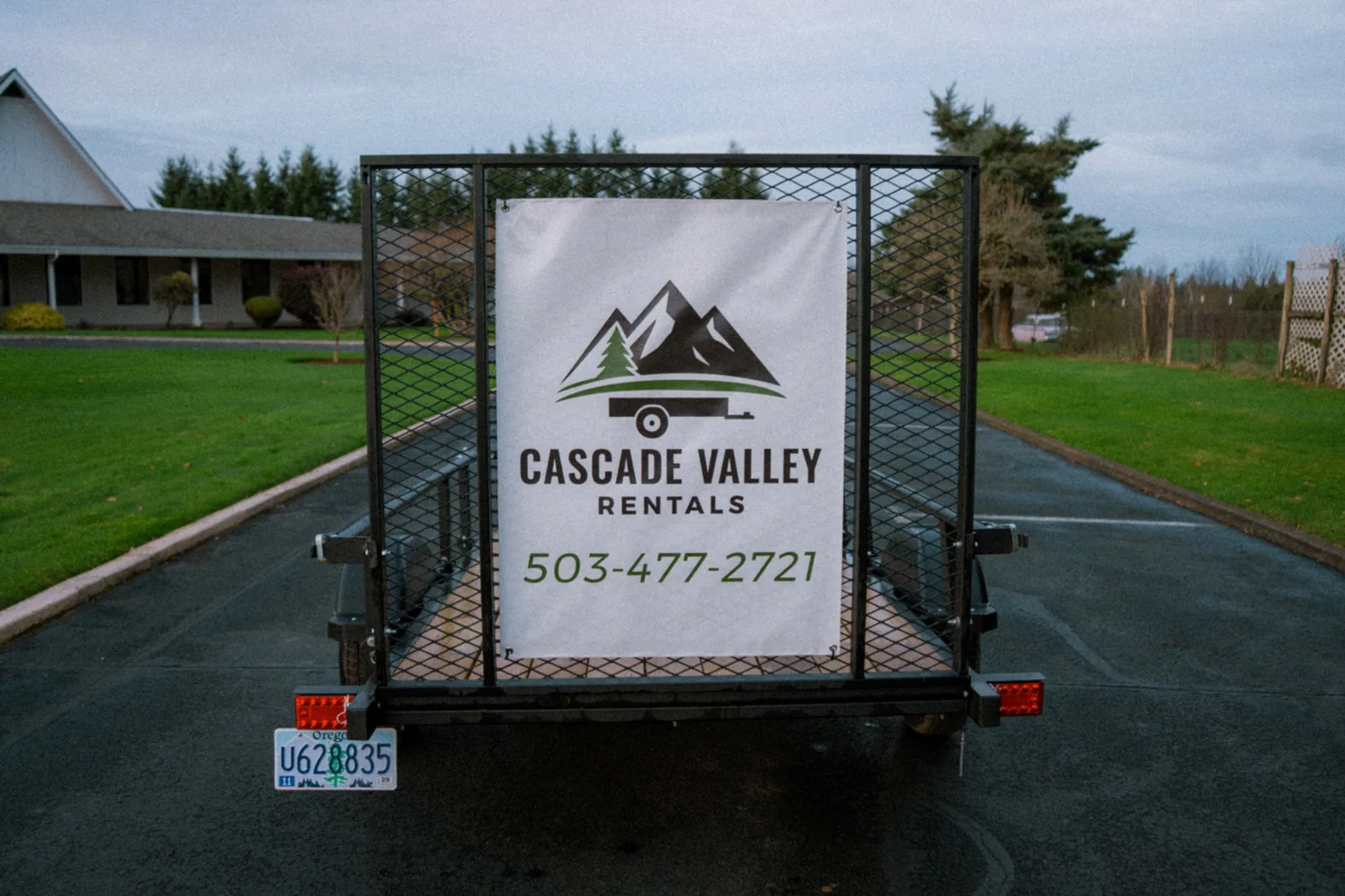 5×8 utility trailer — rear with Cascade Valley banner